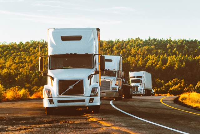 Image of three semitrucks with trailers parked partially off the roadway, representing how Brewer & Giggenbach, PLLC can help you navigate claims if you do get into a truck accident in West Virginia. 